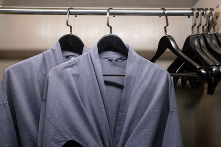 twins bathrobe, security safe in wooden wardrobe in hotelの写真素材