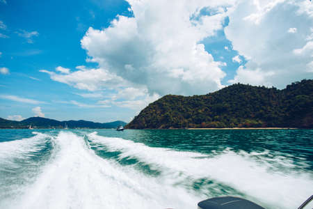 trace tail of speed boat on water surface in the seaの写真素材