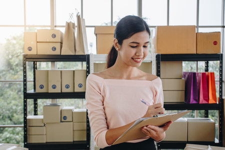 Asian woman writing clipboard, home delivery, SME e-commerce concept