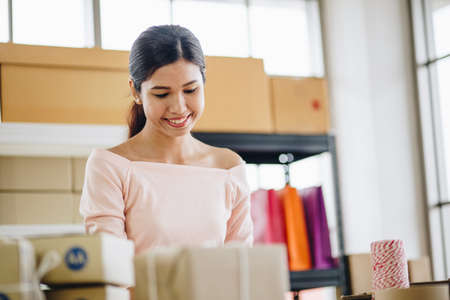 Asian woman writing clipboard, home delivery, SME e-commerce conceptの写真素材