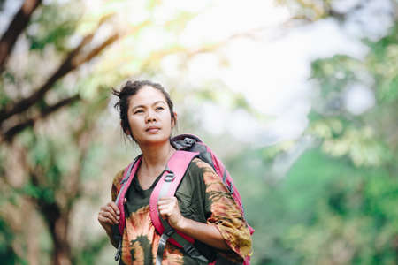 Traveler backpacker Asian woman with nature background , Traveler conceptの写真素材
