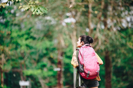 Traveler backpacker Asian woman with nature background , Traveler conceptの写真素材