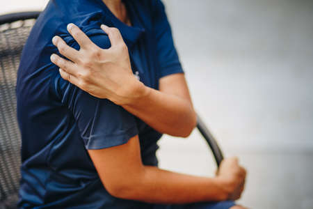 young woman with pain in shoulder, Ache in human body , office syndrome , health care conceptの写真素材