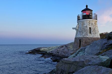 Lighthouse close sea cliffs of sunset waveの写真素材