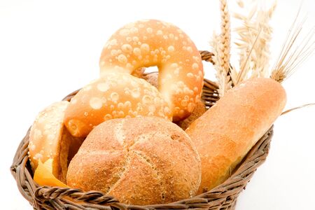 Baking buns bagels muffin in a basket on a white backgroundの写真素材
