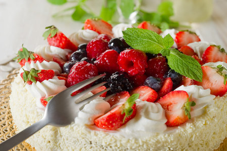 cake with strawberry fruit raspberry fork white cream