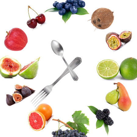 watch from a fruit and spoon fork on a white background.の写真素材