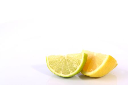 Lime lemon citrus fruit wedges on a white background .の写真素材