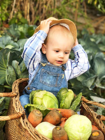 The child is a little farmer. Farm assistant.の写真素材