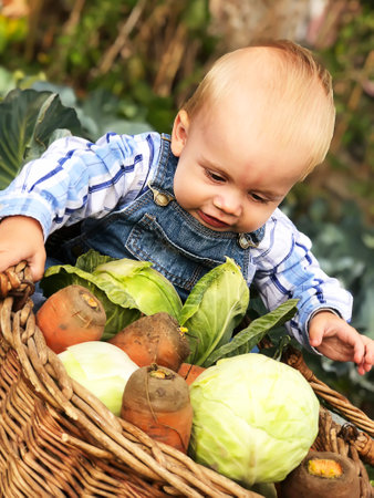 The child is a little farmer. Farm assistant.の写真素材