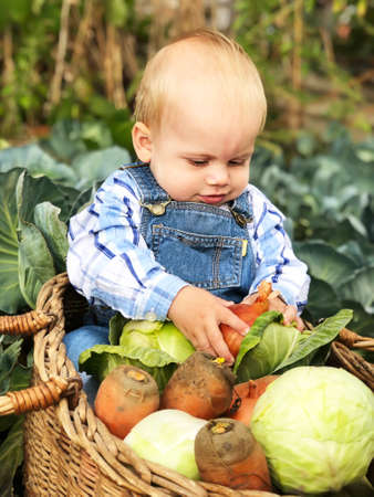 The child is a little farmer. Farm assistant.の写真素材