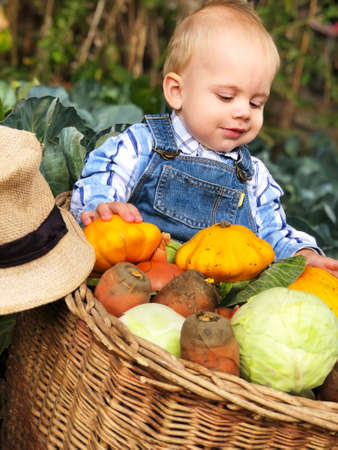 The child is a little farmer. Farm assistant.の写真素材