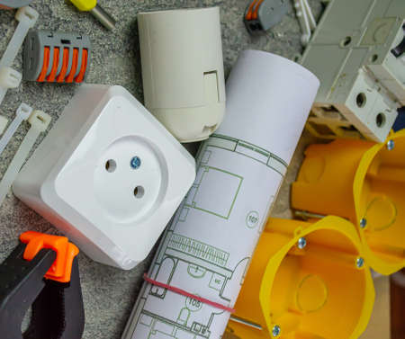 Electrical tools and a set of components for use in electrical installations on a gray background with a place for textの写真素材