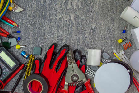 Electrical tools and a set of components for use in electrical installations on a gray background with a place for textの写真素材