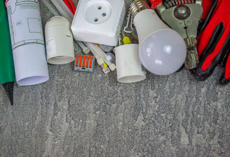 Electrical tools and a set of components for use in electrical installations on a gray background with a place for textの写真素材