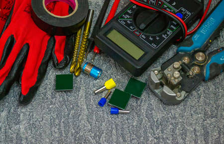 Electrical tools and a set of components for use in electrical installations on a gray background with a place for textの写真素材