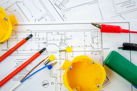 Flat lay composition with electrician's tools on house plan. Space for textの写真素材