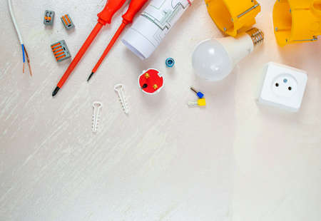 Flat lay composition with electrician's tools on wooden backgroundの写真素材