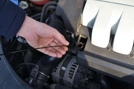 Mechanic repairs car in a car repair stationの写真素材