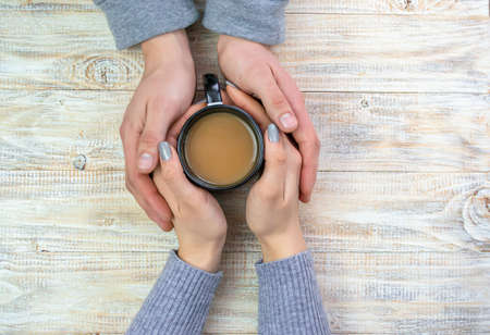 Concept of male and female hands, love and coffeeの写真素材