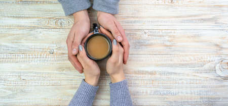 Concept of male and female hands, love and coffeeの写真素材