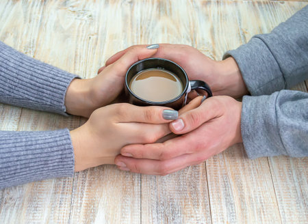 Concept of male and female hands, love and coffeeの写真素材