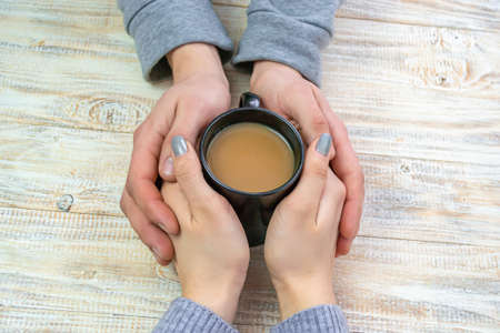 Concept of male and female hands, love and coffeeの写真素材