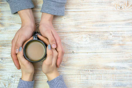 Concept of male and female hands, love and coffeeの写真素材