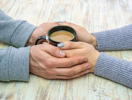 Concept of male and female hands, love and coffeeの写真素材