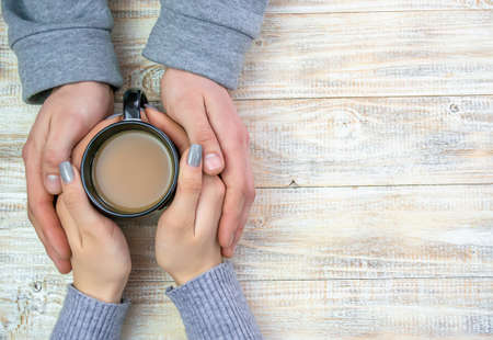 Concept of male and female hands, love and coffeeの写真素材