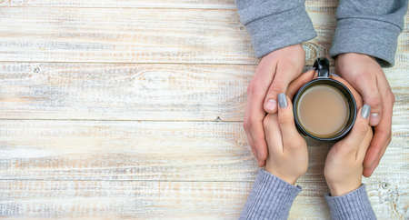 Concept of male and female hands, love and coffeeの写真素材