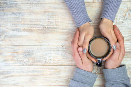 Concept of male and female hands, love and coffeeの写真素材