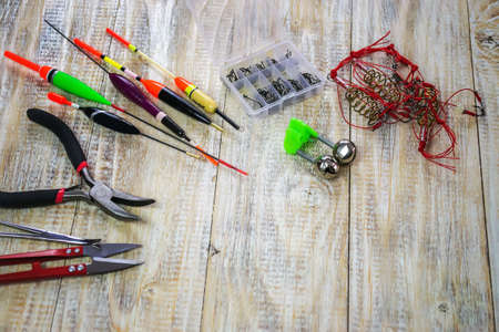 fishing tackles for anglers - swimmers, plummets and tools on wooden background. Selective focusの写真素材