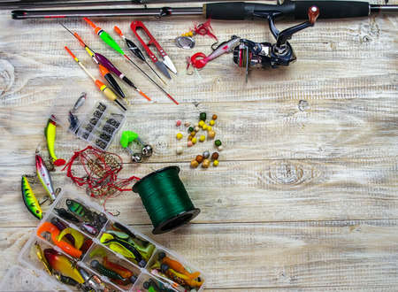 lot of colorful lures with the fishing rod on the wooden pierの写真素材
