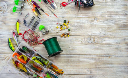 lot of colorful lures with the fishing rod on the wooden pierの写真素材