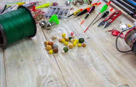 lot of colorful lures with the fishing rod on the wooden pierの写真素材
