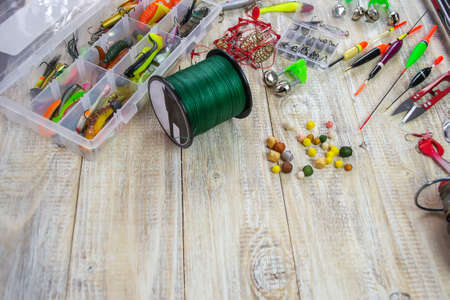 lot of colorful lures with the fishing rod on the wooden pierの写真素材