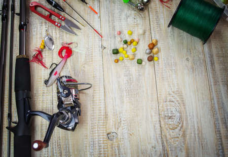 lot of colorful lures with the fishing rod on the wooden pierの写真素材