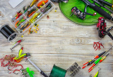 lot of colorful lures with the fishing rod on the wooden pierの写真素材