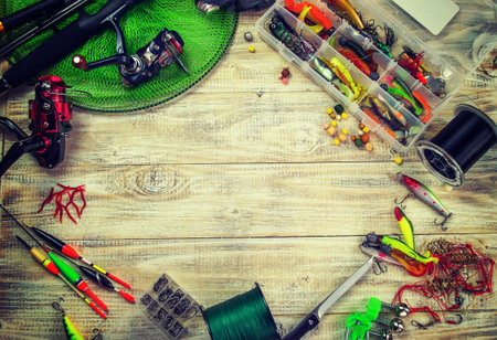 lot of colorful lures with the fishing rod on the wooden pierの写真素材