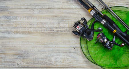 Fishing tackle, many colorful baits with a fishing rod on a wooden pier. Selective focusの写真素材
