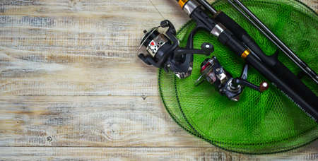 Fishing tackle, many colorful baits with a fishing rod on a wooden pier. Selective focusの写真素材