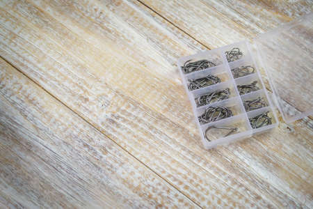 Fishing tackle, many colorful baits with a fishing rod on a wooden pier. Selective focusの写真素材