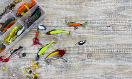 Fishing tackle. Float, wobbler, bait hooks, on a wooden background. Selective focusの写真素材