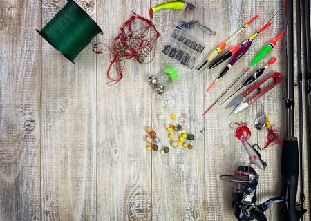 Fishing tackle. Float, wobbler, bait hooks, on a wooden background. Selective focusの写真素材