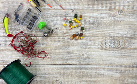 Fishing tackle. Float, wobbler, bait hooks, on a wooden background. Selective focusの写真素材