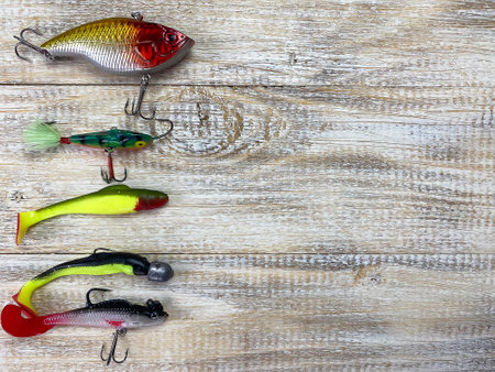 Fishing tackle. Float, wobbler, bait hooks, on a wooden background. Selective focusの写真素材