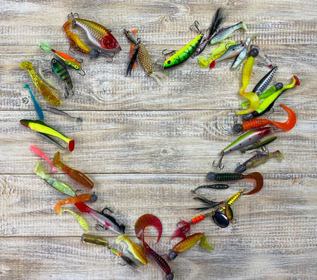 Fishing tackle. Float, wobbler, bait hooks, on a wooden background. Selective focusの写真素材