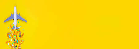 model airplane with multicolored pills from motion sickness close-up on a yellow background. concept illness in travel.selective focusの写真素材