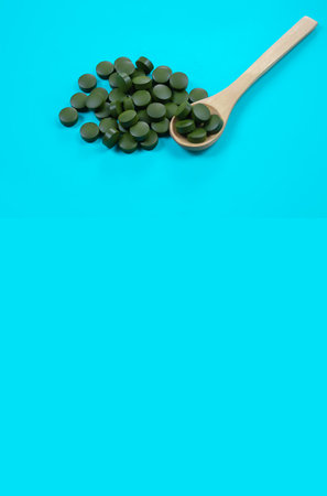 Composition with spirulina powder and pills on color backgroundの写真素材